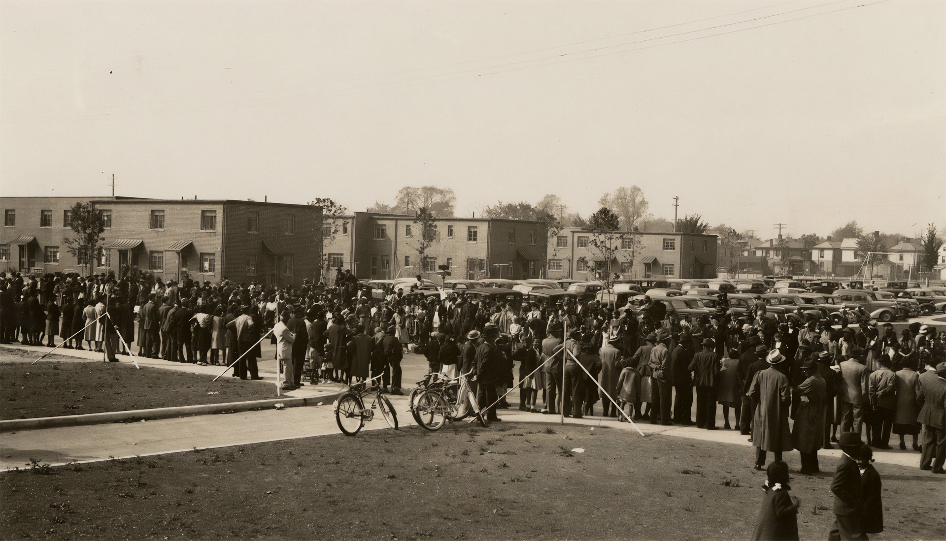 Poindexter Village, a crowd gathers to see the finished housing and if it indeed had the amenities promised in its promotion.