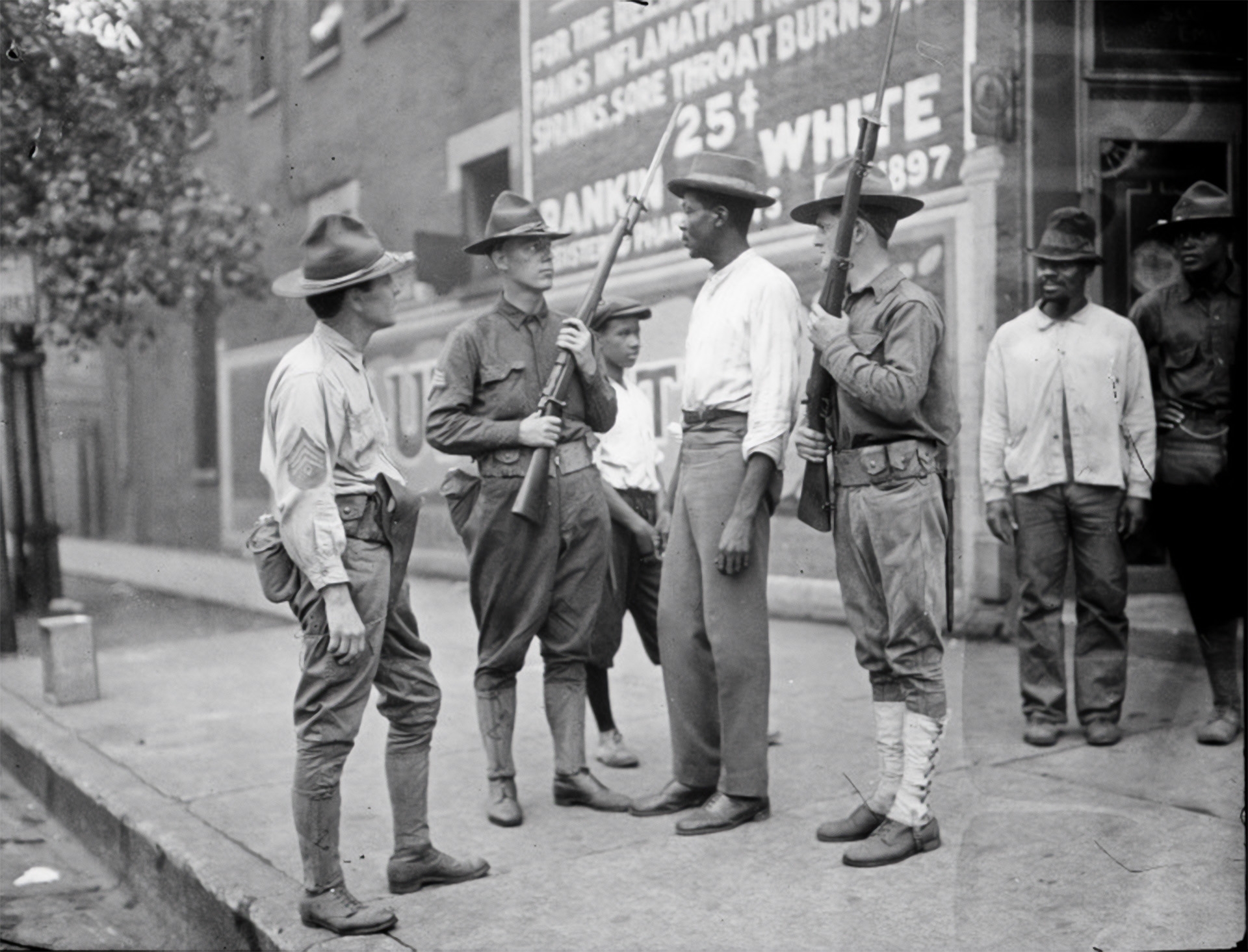 A Black man stands in the middle of National Guard soldiers in Chicago during the 1919 Chicago Race Riot.