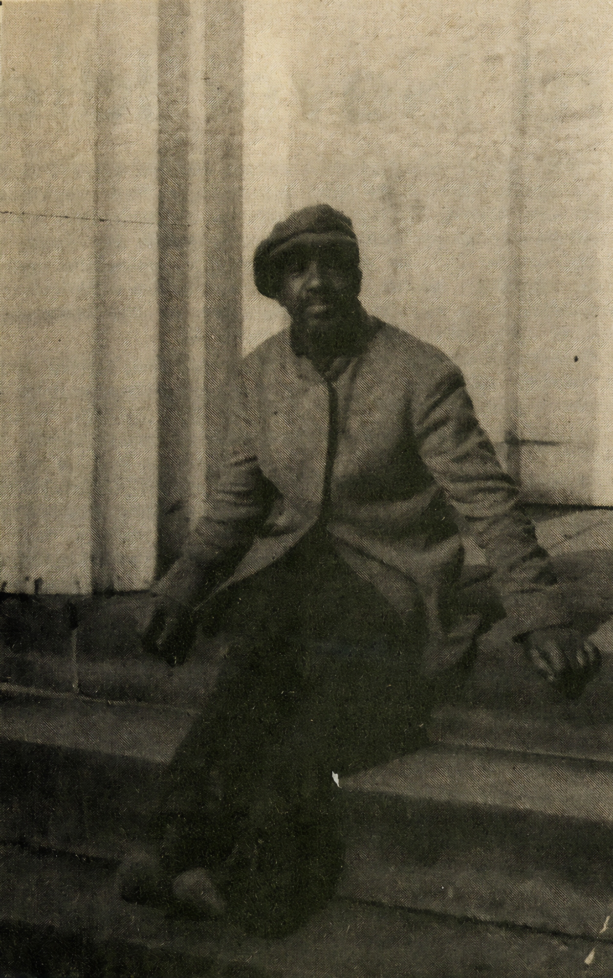 George Pine lived in West Hartford and worked odd jobs, as a jack-of-all-trades. In this undated photograph, he rests on steps in the center of town.