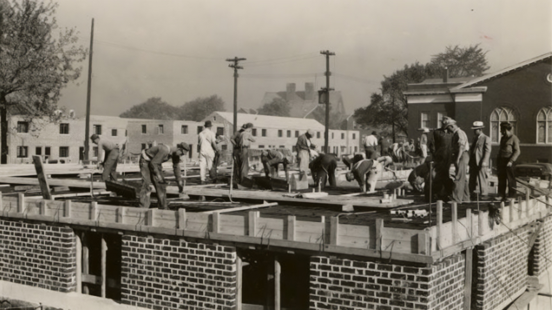 Dated September 22, 1939, this photograph shows construction workers preparing to pour concrete for the main floor slab of the administration building at Poindexter Village.